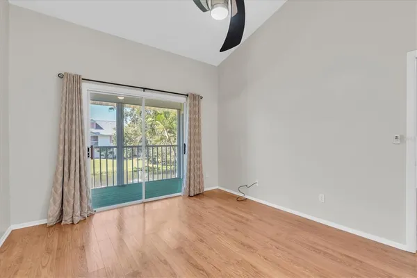 a view of a room with wooden floor and windows