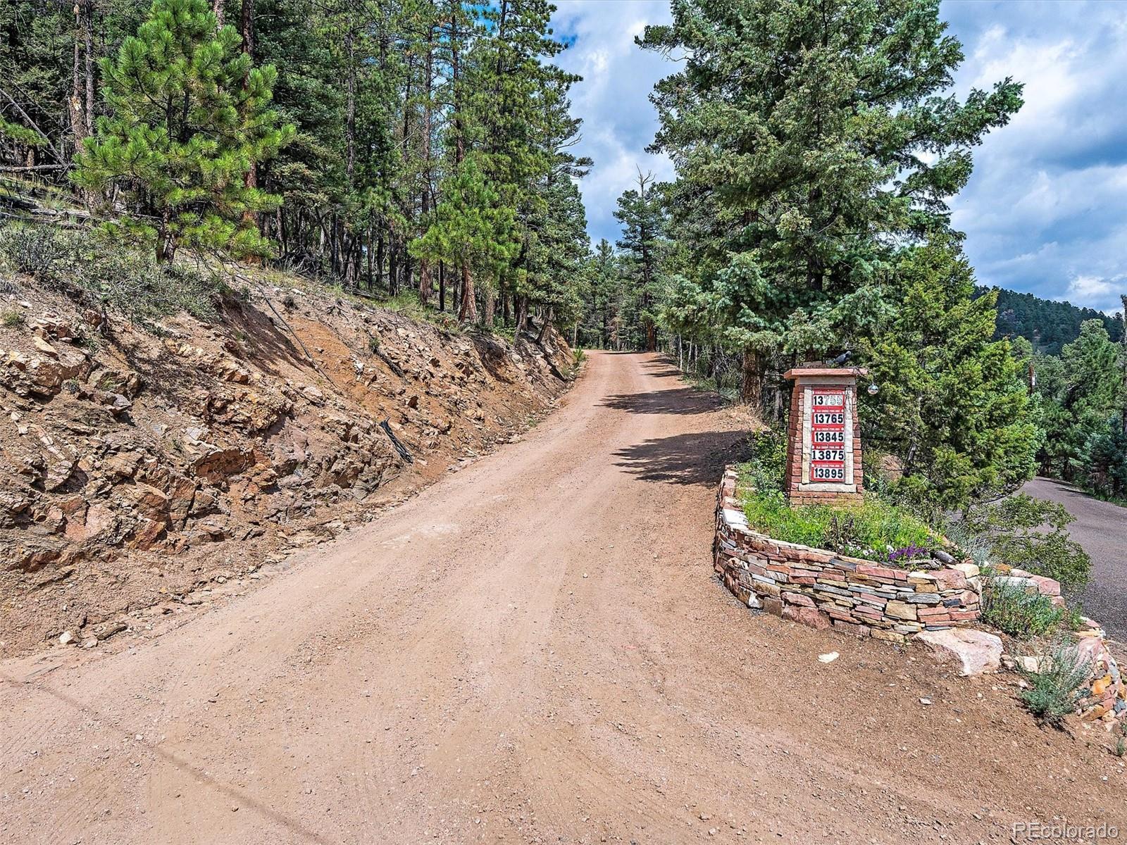 13745 Shiloh Drive Conifer, CO 80433 - Photo 2 of 20 a front view of a house with a yard