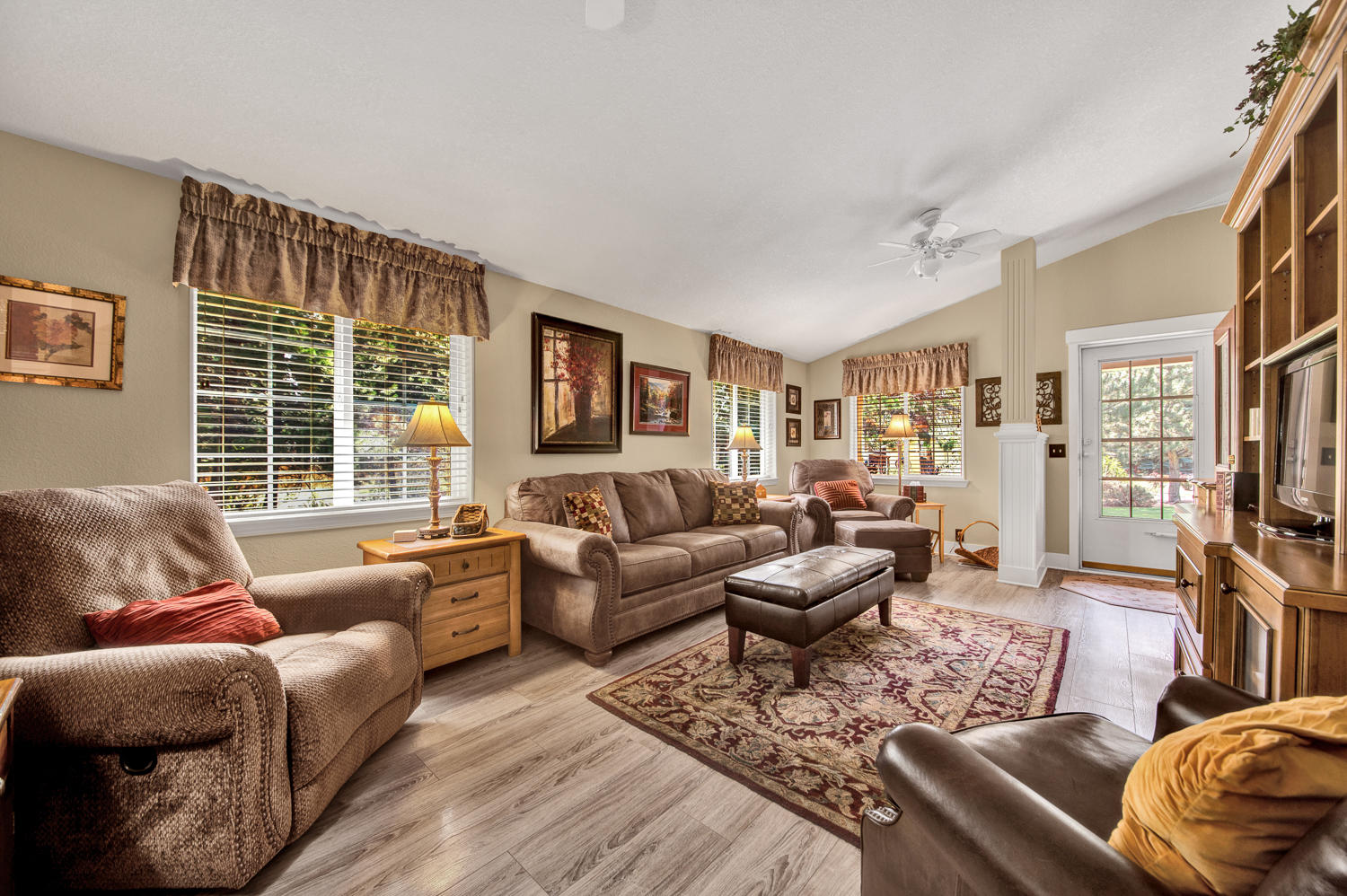 19166 Choctaw Road Bend, OR 97702 - Photo 12 of 23 a living room with furniture a flat screen tv and a large window