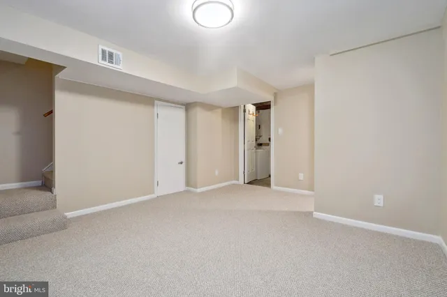 a view of an empty room and a window