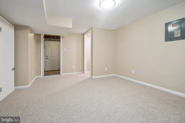 a view of an empty room and closet area