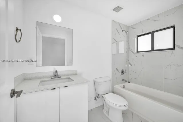 an aerial view of residential building with green space