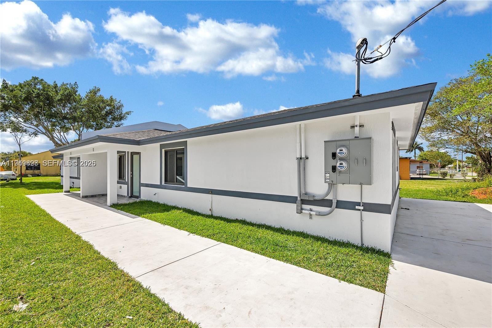 673 Northwest 14th Street, Unit 1 Florida City, FL 33034 - Photo 20 of 21 a patio with table and chairs
