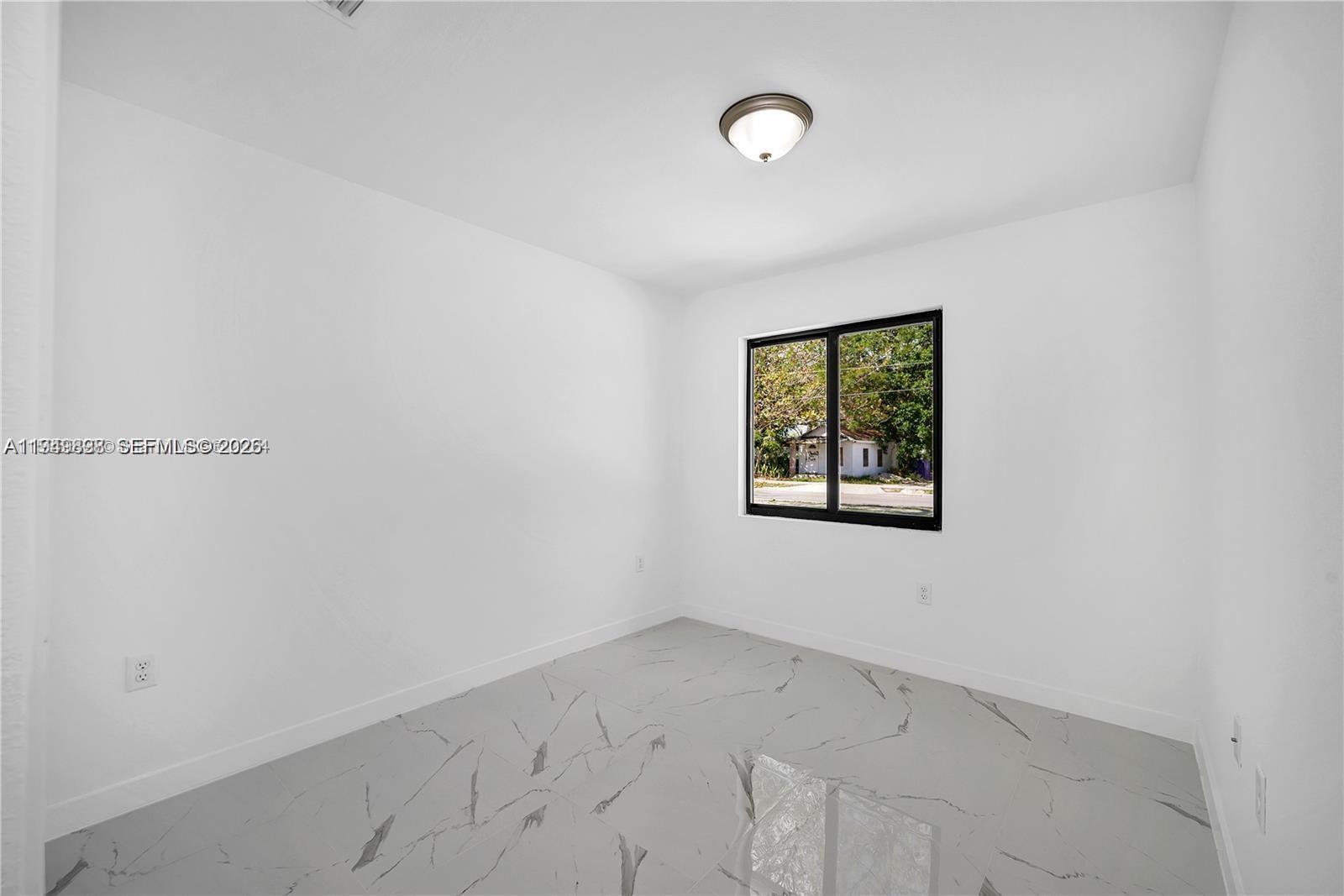 673 Northwest 14th Street, Unit 1 Florida City, FL 33034 - Photo 3 of 21 an empty room with a window