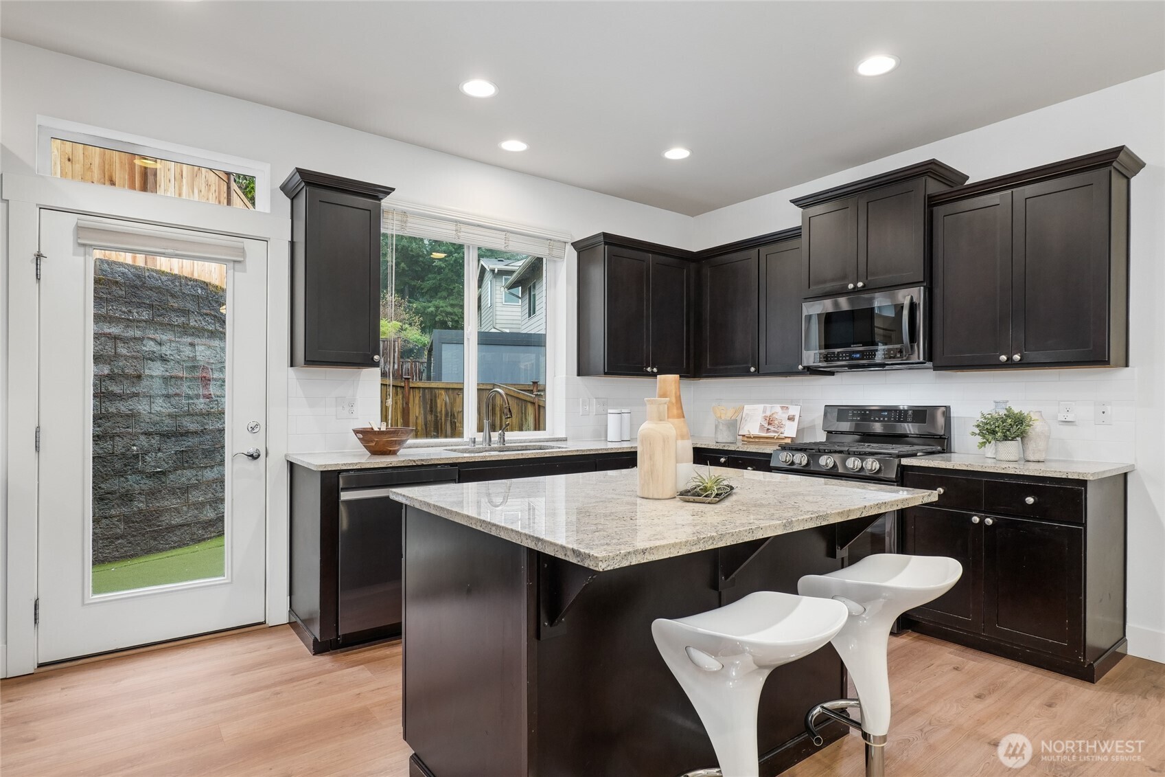 12823 65th Place West Edmonds, WA 98026 - Photo 11 of 32 a kitchen with granite countertop a sink stove and refrigerator