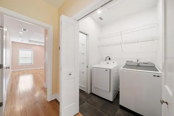 a utility room with closet dryer and washer