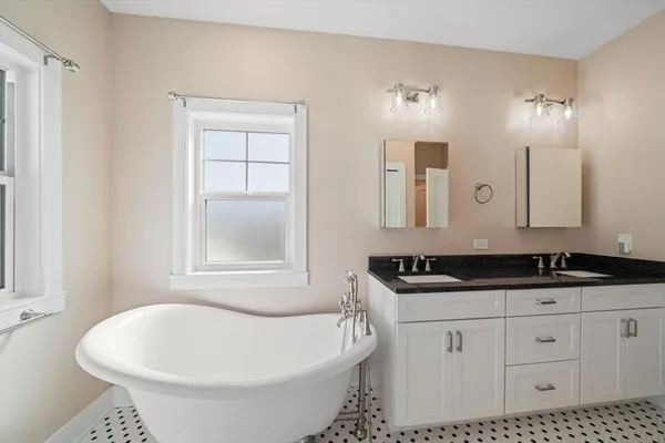 a kitchen with granite countertop a sink stainless steel appliances and cabinets