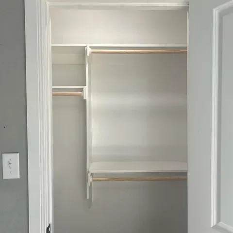 a bathroom with a granite countertop sink a mirror and shower