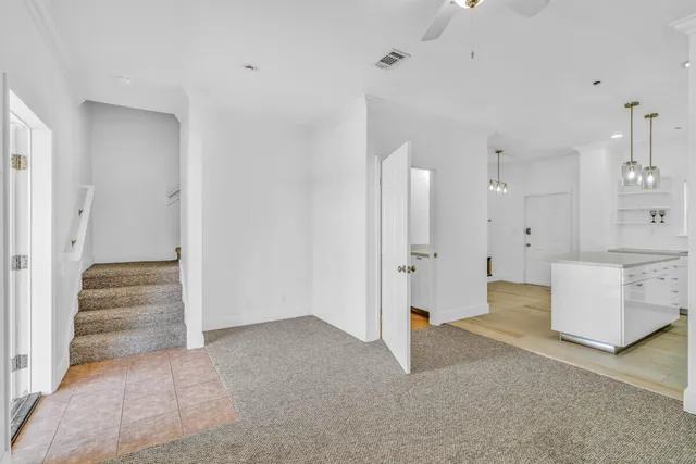 a view of a room with large windows and cabinet