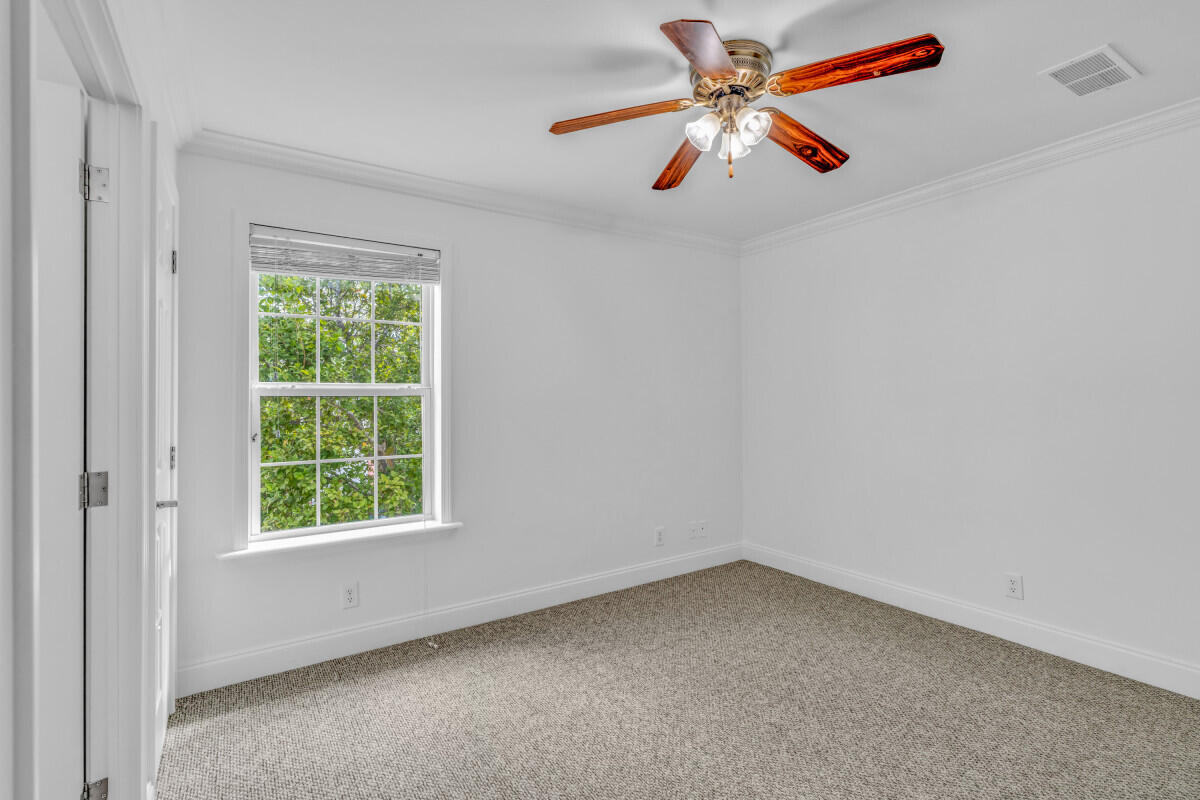 98980 Overseas Highway Key Largo, FL 33037 - Photo 5 of 12 an empty room with ceiling fan and window