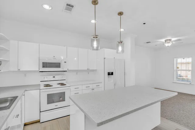 a kitchen with a stove a sink and a refrigerator