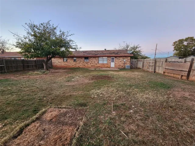 a kitchen with a stove sink and cabinets