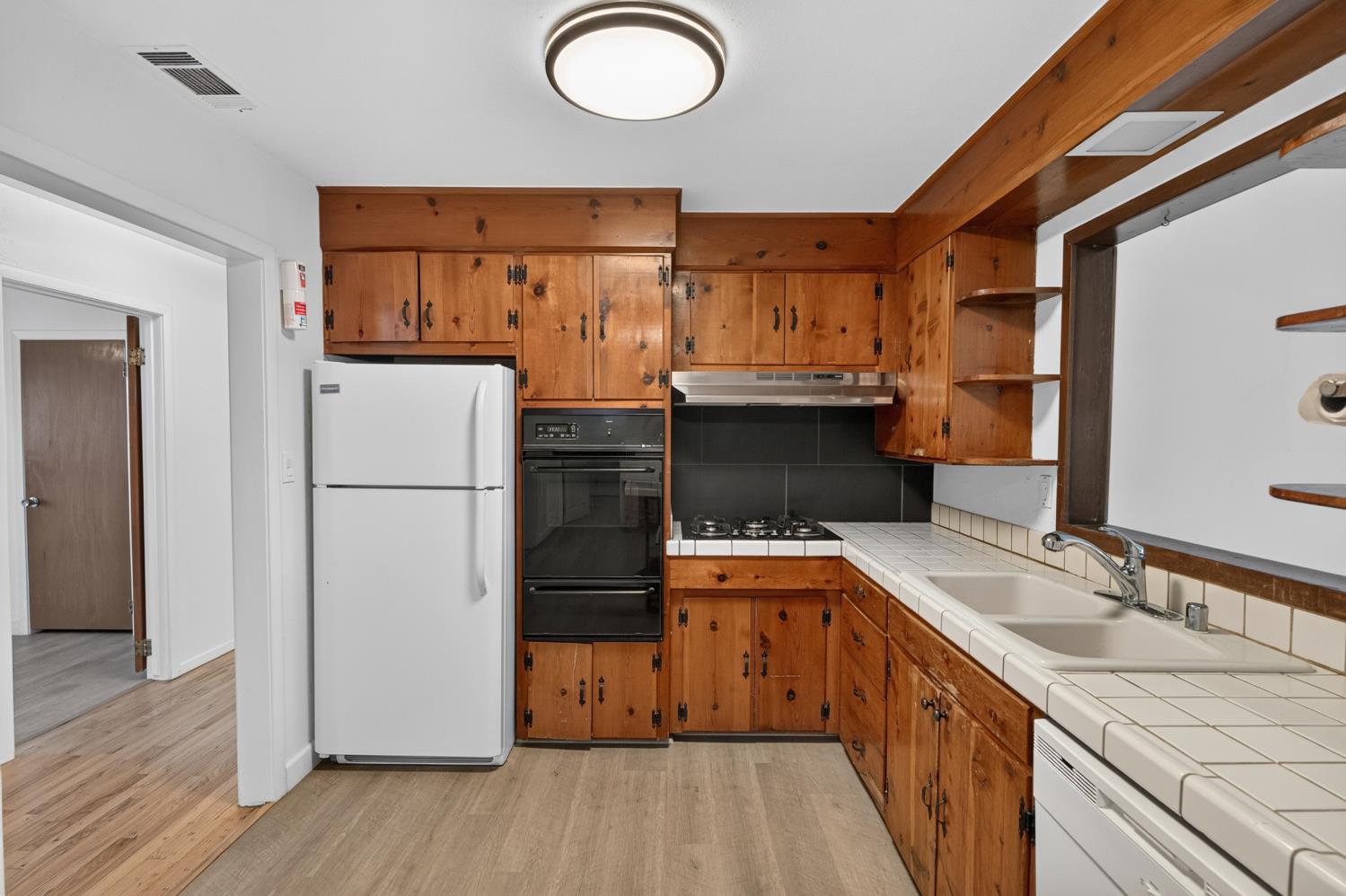 10700 Calvine Road Elk Grove, CA 95830 - Photo 21 of 73 a kitchen with a sink refrigerator and cabinets