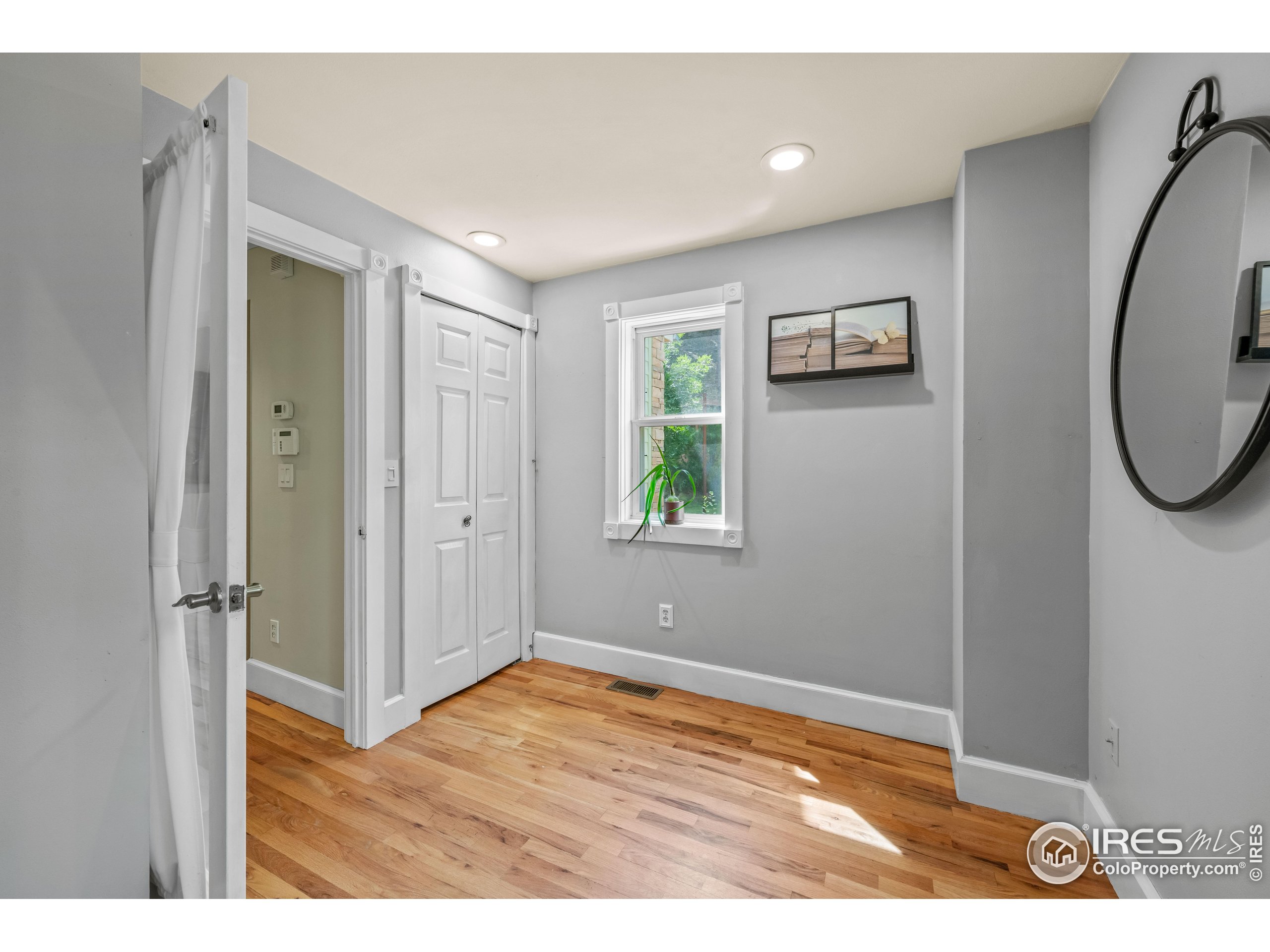 301 Valley Lane Boulder, CO 80302 - Photo 11 of 46 a view of an empty room with wooden floor and a window