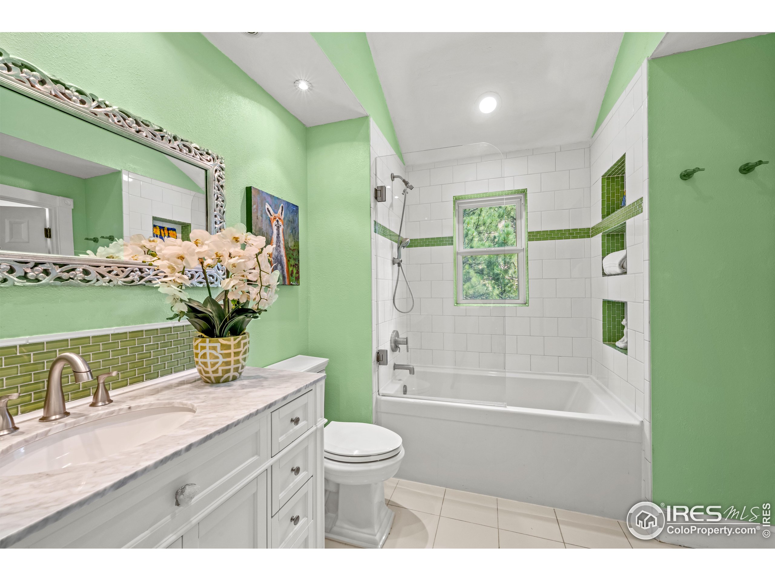 301 Valley Lane Boulder, CO 80302 - Photo 15 of 46 a bathroom with a granite countertop sink a toilet a mirror and bathtub