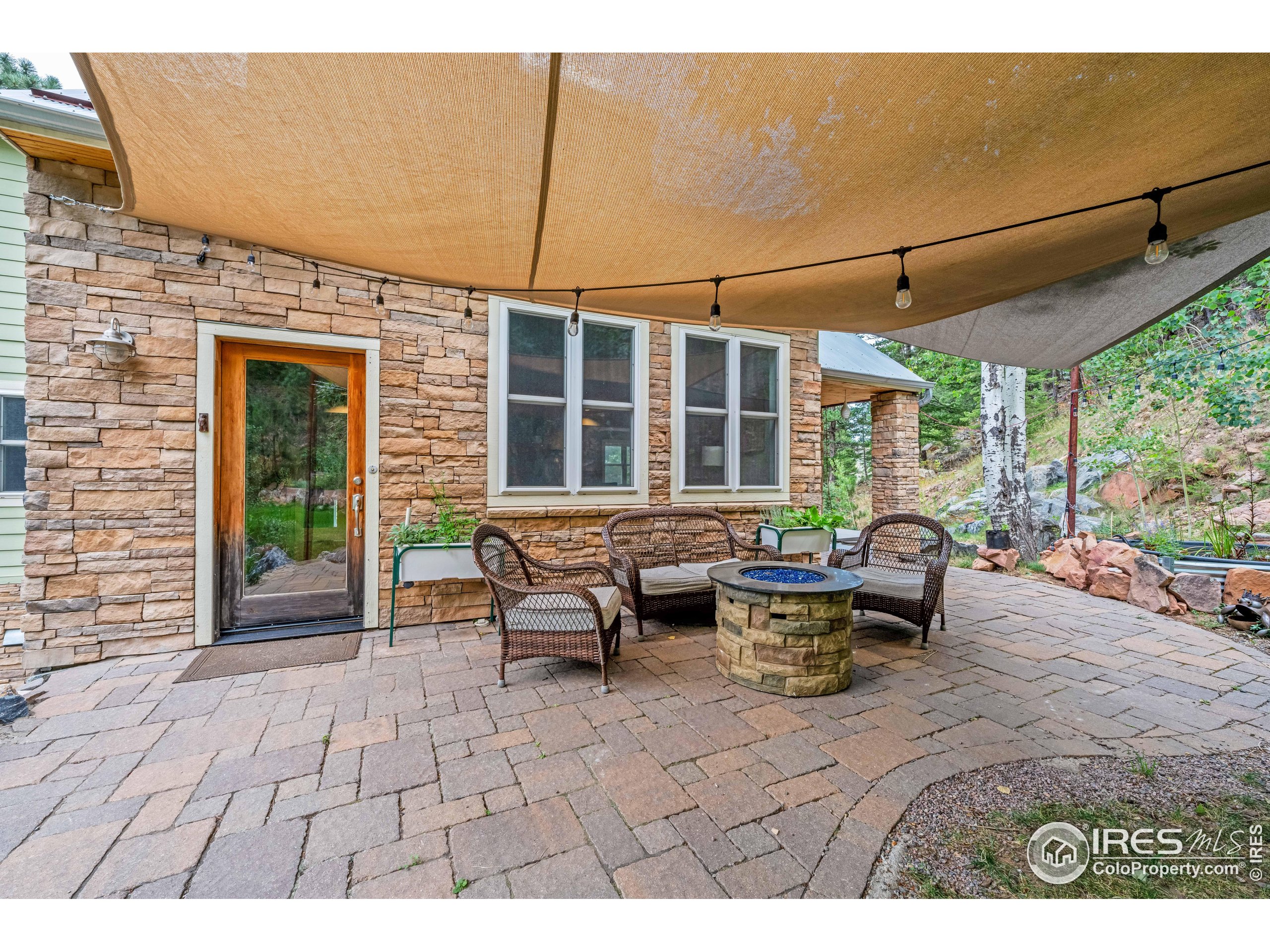 301 Valley Lane Boulder, CO 80302 - Photo 31 of 46 a view of a patio with table and chairs and wooden fence