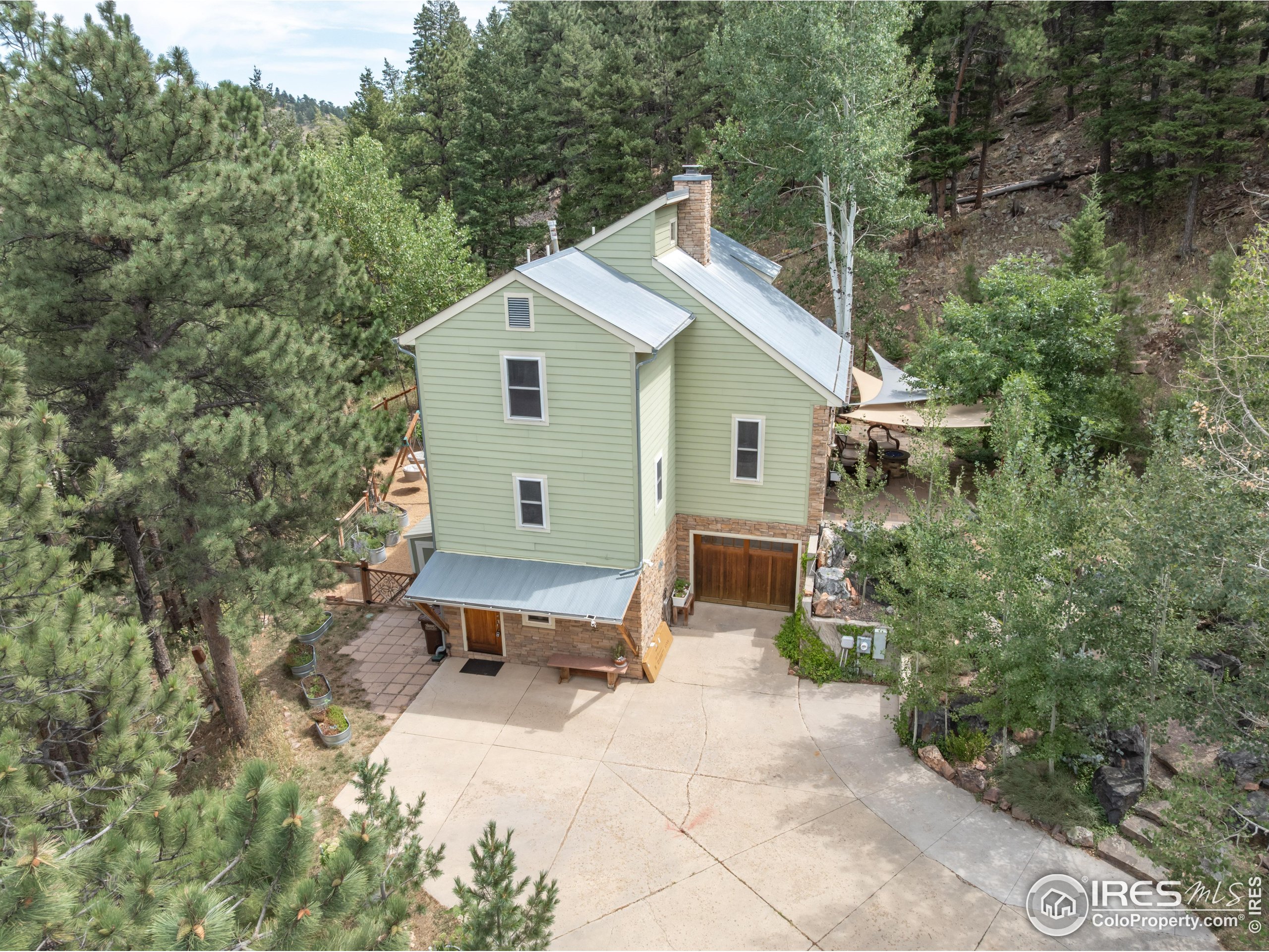301 Valley Lane Boulder, CO 80302 - Photo 37 of 46 a view of a house with a yard and sitting area