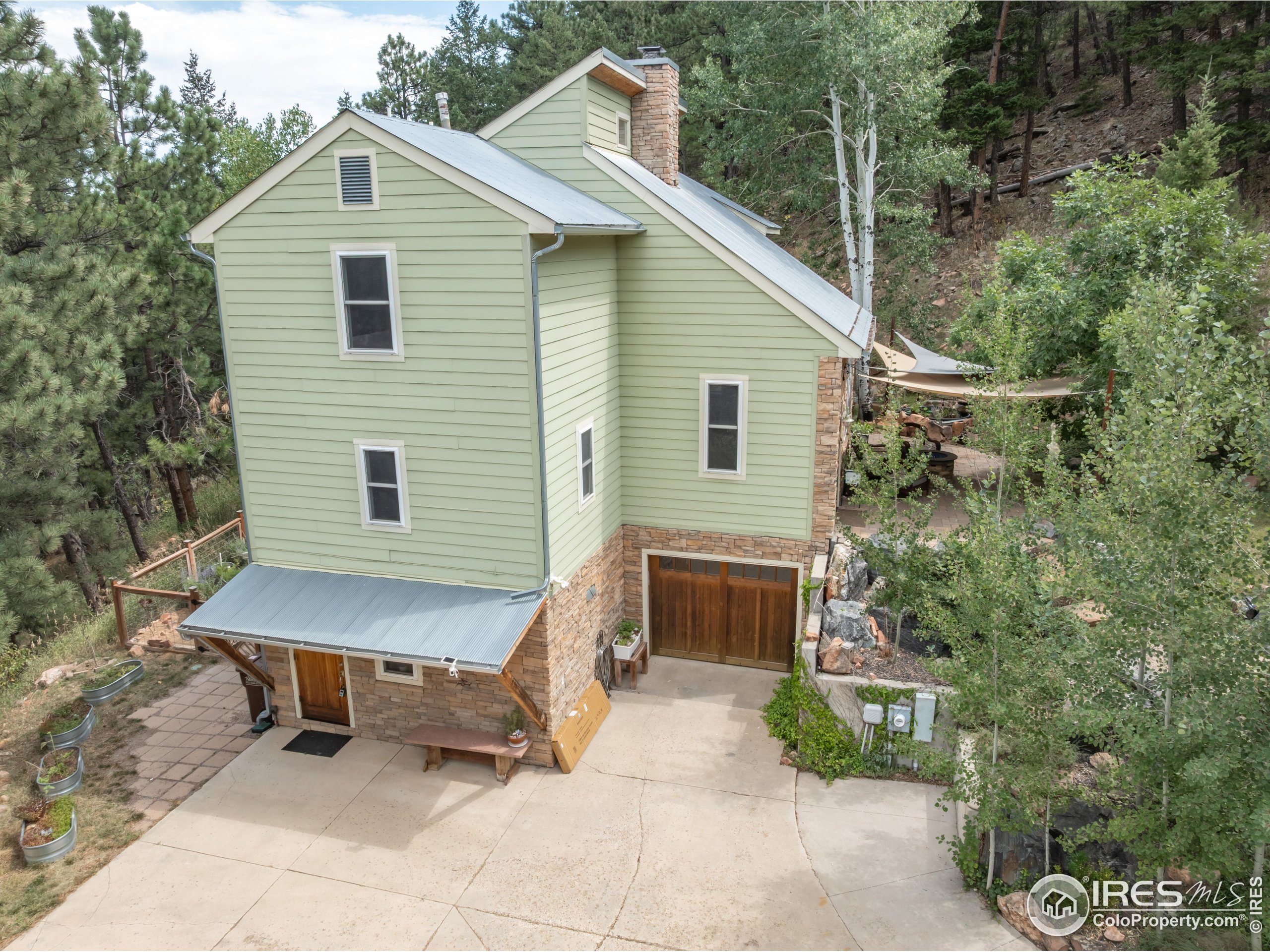 301 Valley Lane Boulder, CO 80302 - Photo 39 of 46 a view of a patio with table and chairs with wooden fence and plants