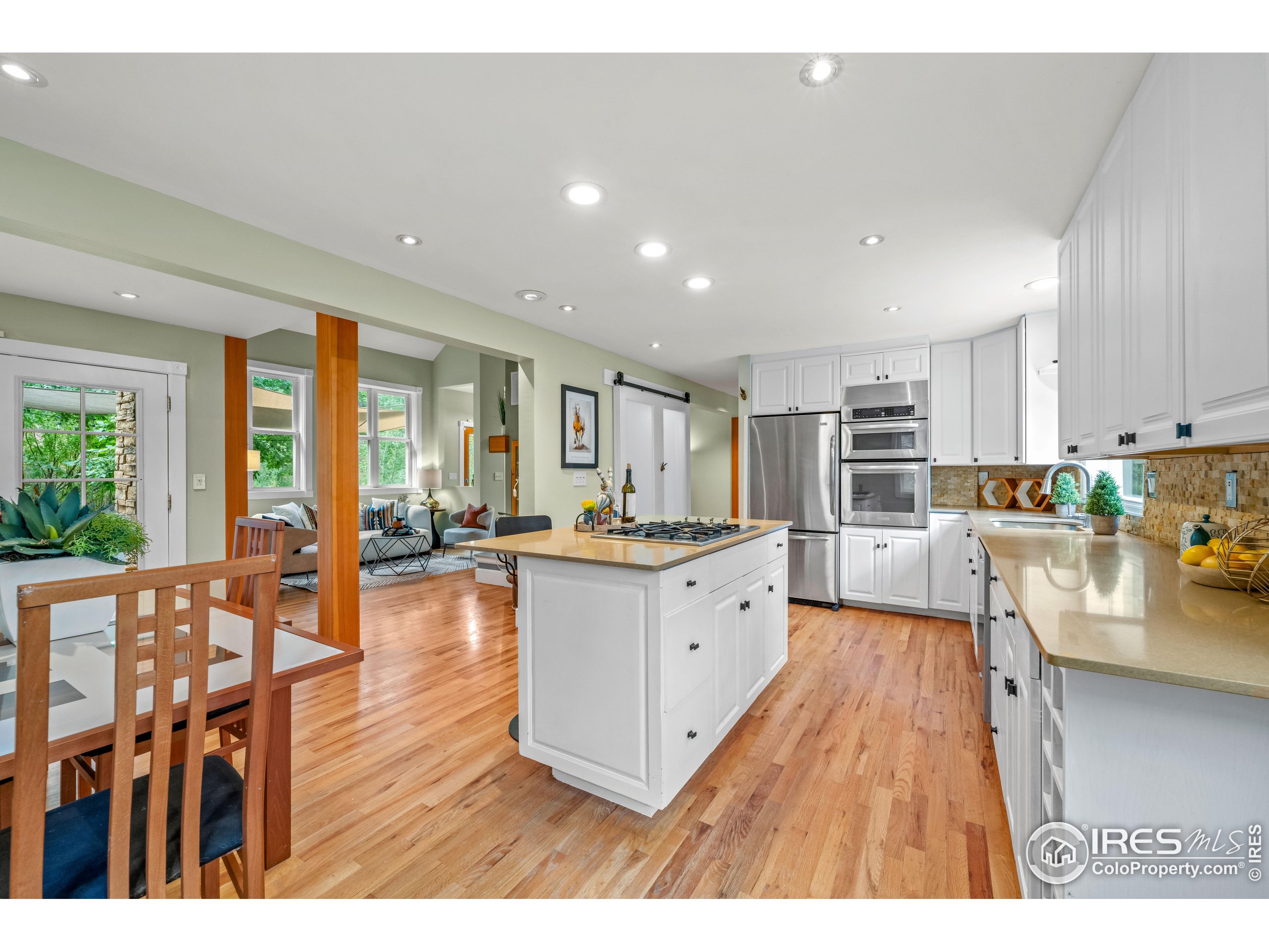 301 Valley Lane Boulder, CO 80302 - Photo 4 of 46 a open kitchen with granite countertop a stove top oven a sink a dining table and chairs