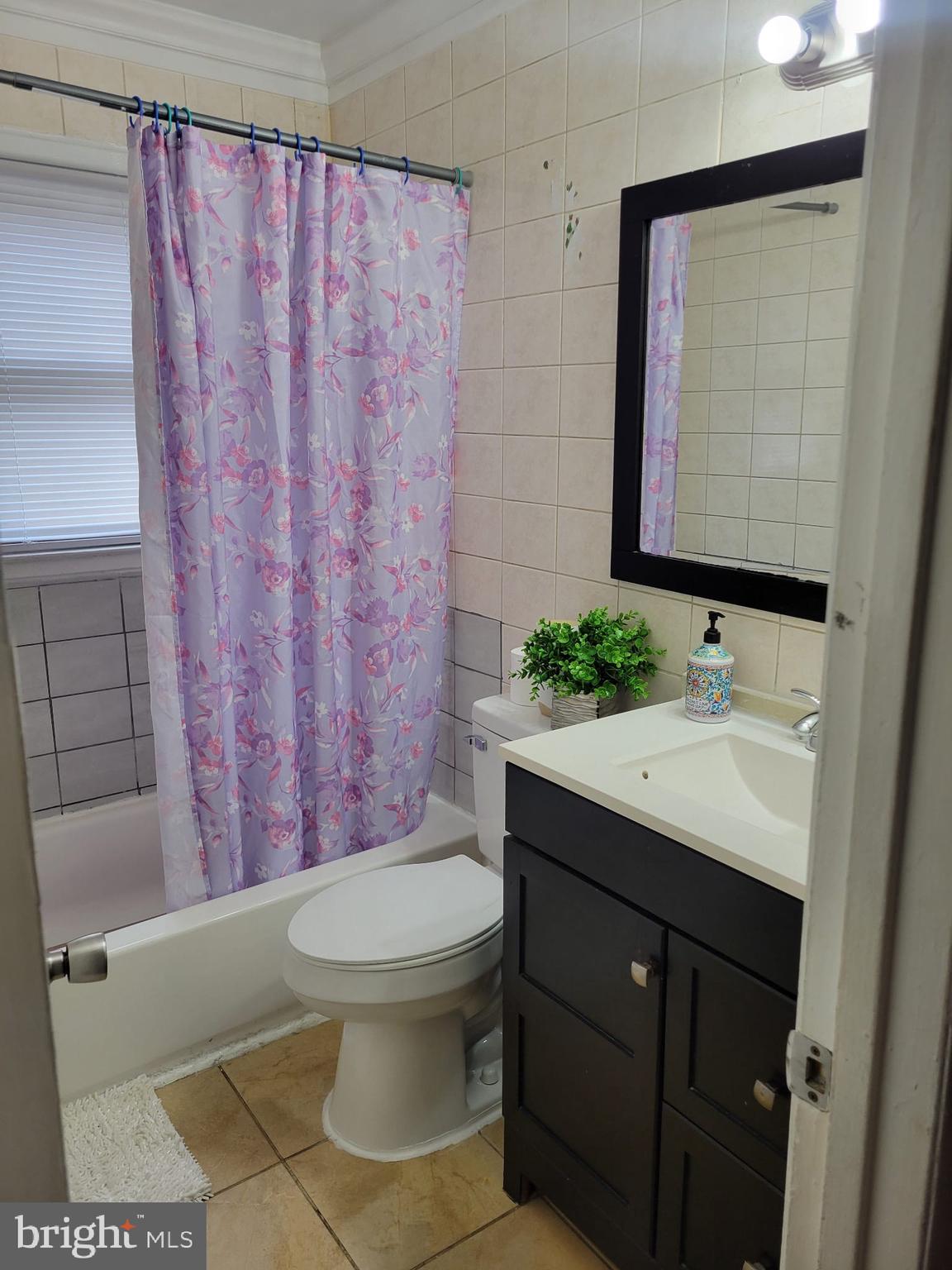 10019 Lomond Drive Manassas, VA 20109 - Photo 12 of 31 a bathroom with a sink a toilet and shower curtain