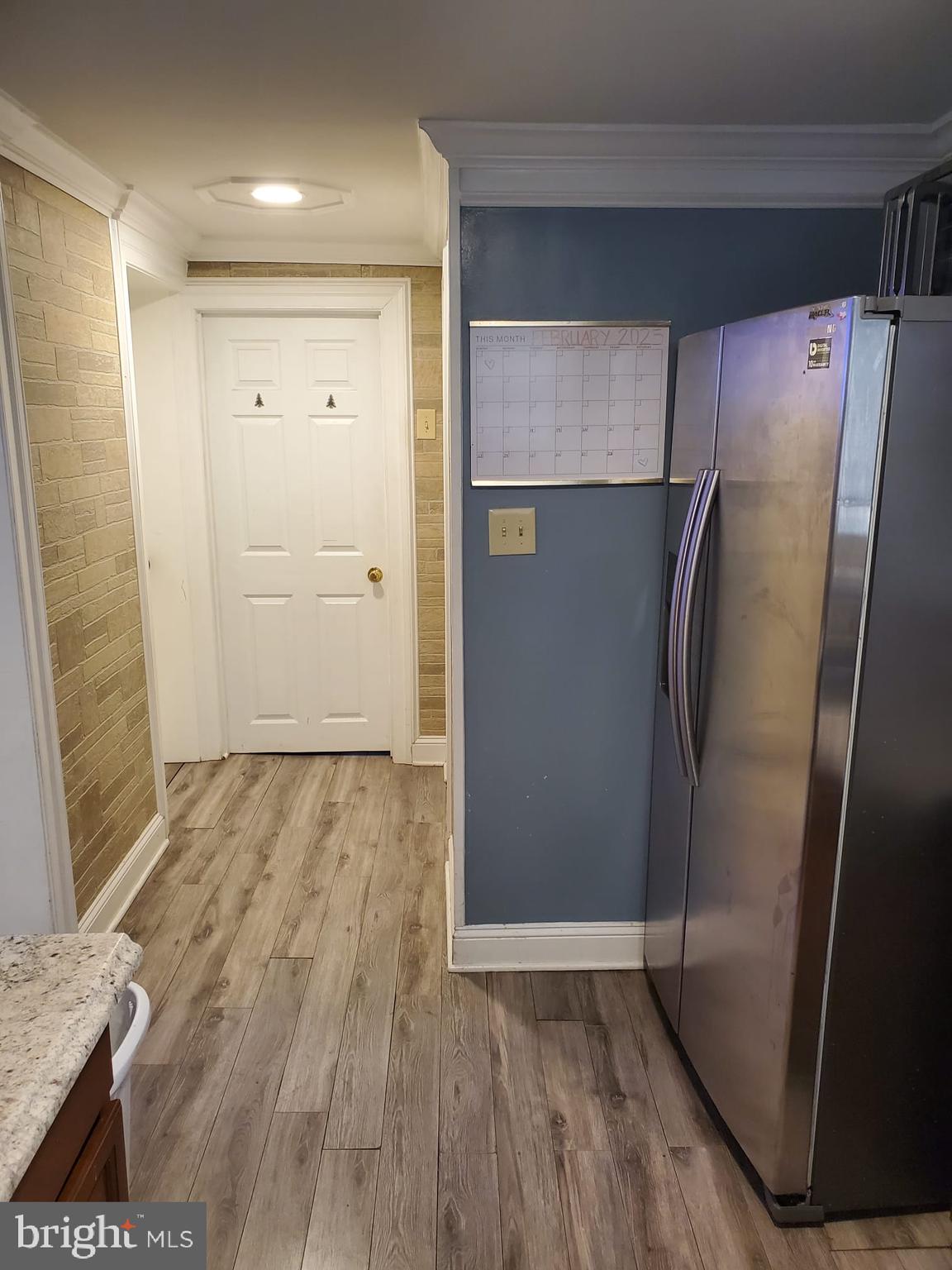10019 Lomond Drive Manassas, VA 20109 - Photo 24 of 31 a view of a refrigerator in kitchen and wooden floor