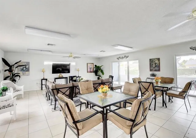 a view of a dining room with furniture and a kitchen