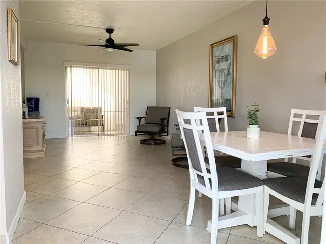 a view of a dining room with furniture and a chandelier