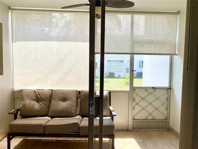 a living room with a large window and a table