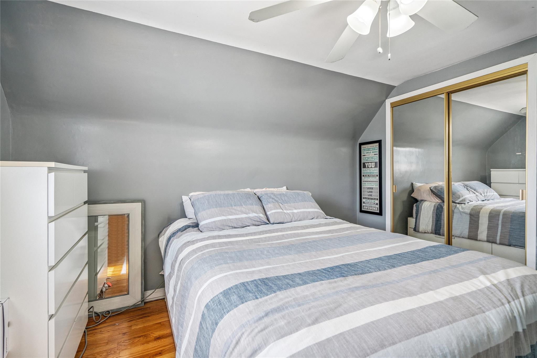 12 Westmoreland Road Merrick, NY 11566 - Photo 24 of 42 a bedroom with a bed and a large mirror