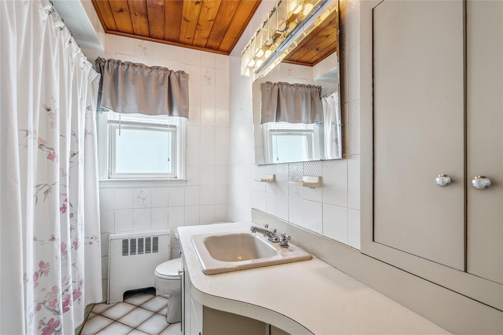 12 Westmoreland Road Merrick, NY 11566 - Photo 29 of 42 a bathroom with a sink toilet and shower