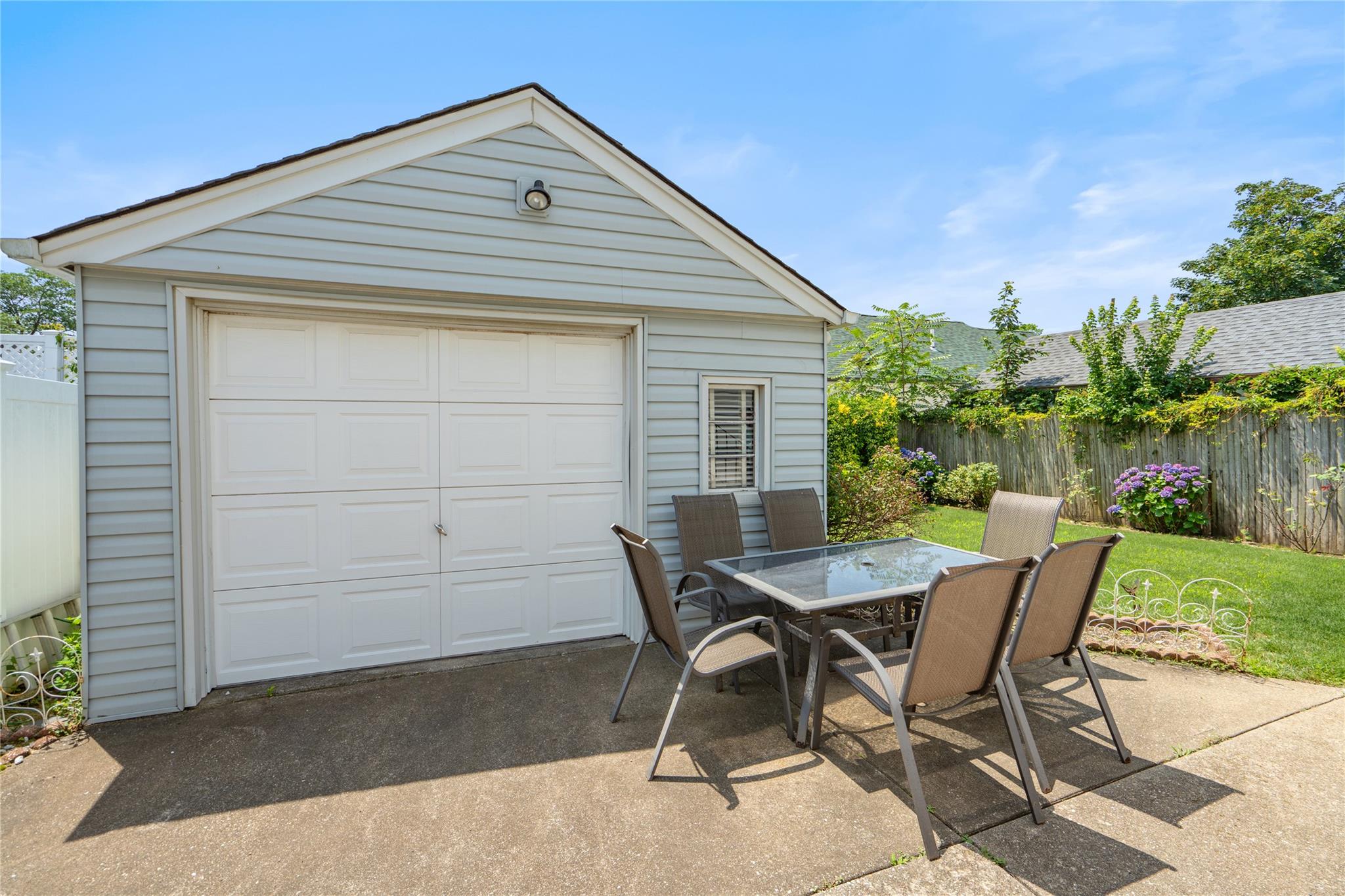 12 Westmoreland Road Merrick, NY 11566 - Photo 3 of 42 a backyard of a house with table and chairs