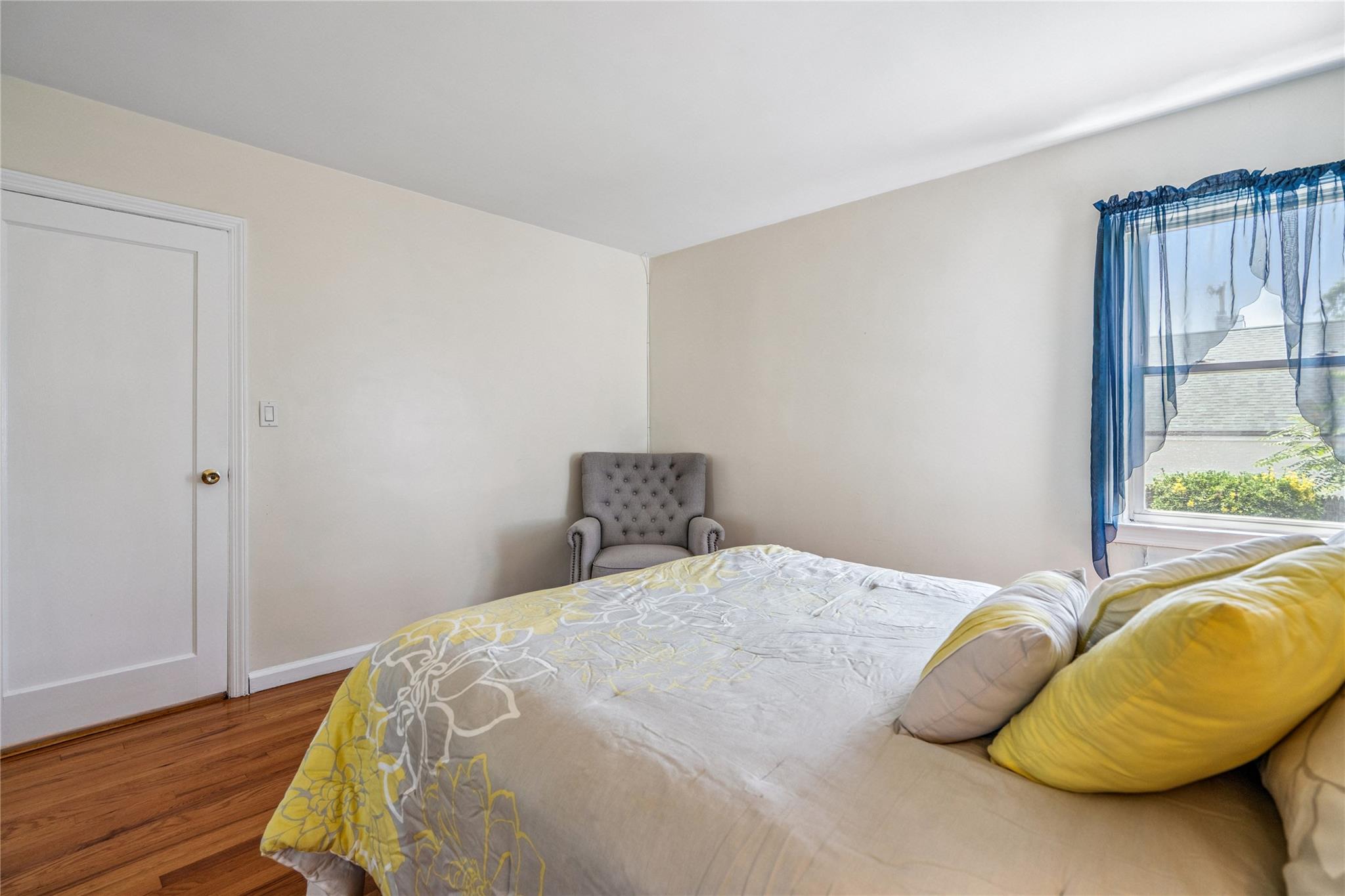 12 Westmoreland Road Merrick, NY 11566 - Photo 31 of 42 a bedroom with a bed and wooden floor