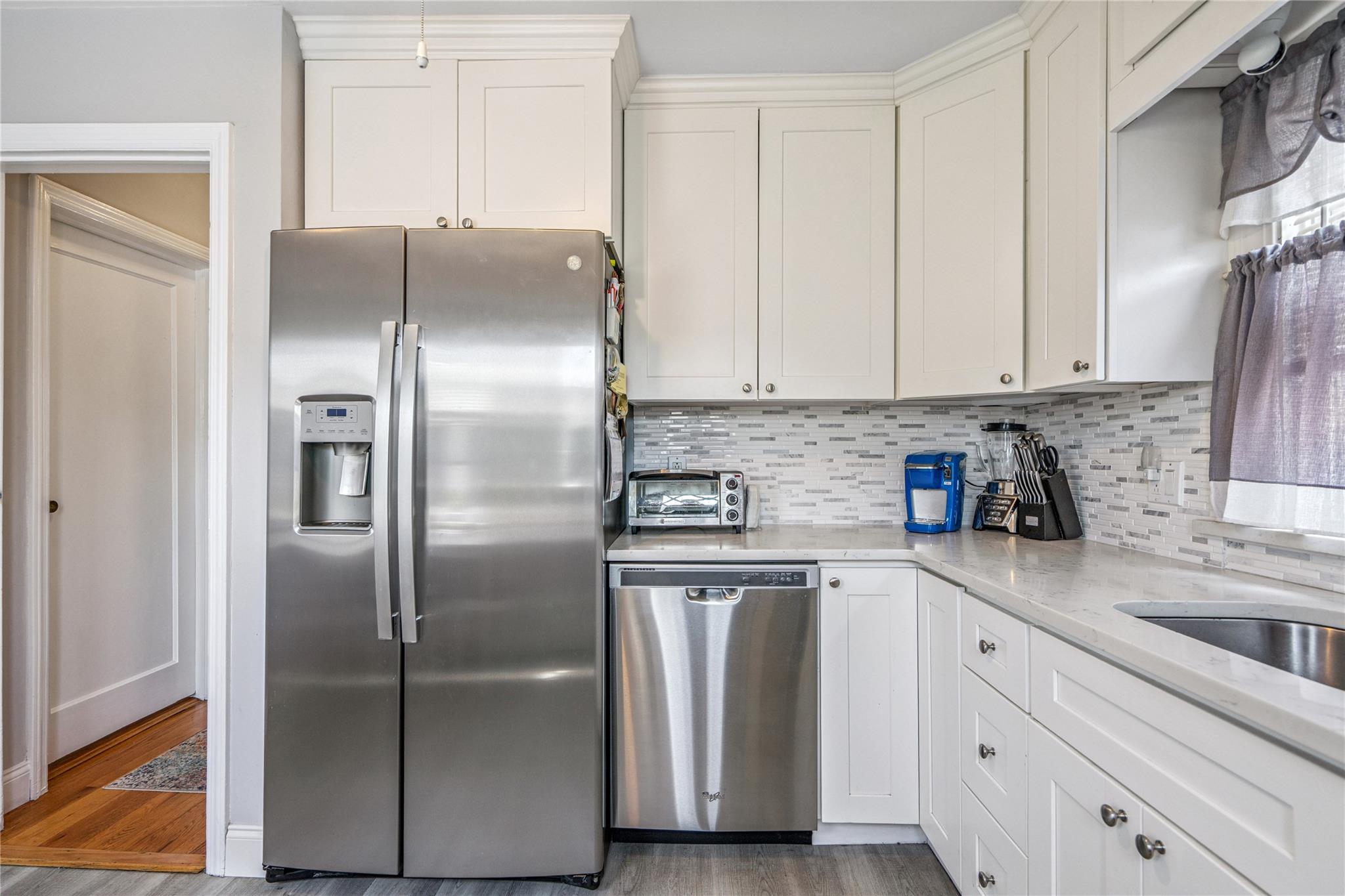 12 Westmoreland Road Merrick, NY 11566 - Photo 35 of 42 a kitchen with stainless steel appliances cabinets a sink and a counter space