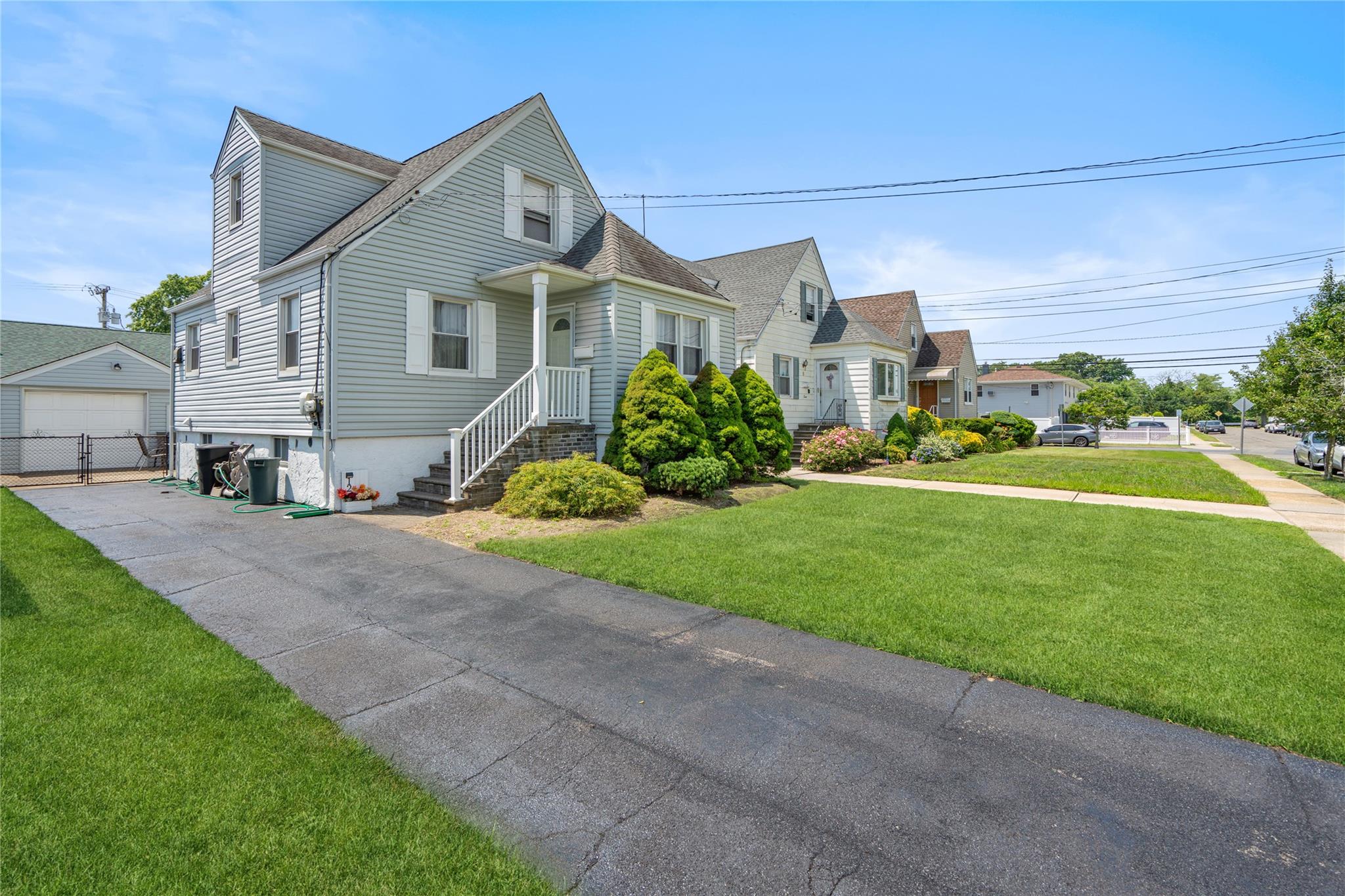 12 Westmoreland Road Merrick, NY 11566 - Photo 8 of 42 a front view of a house with a yard and garage