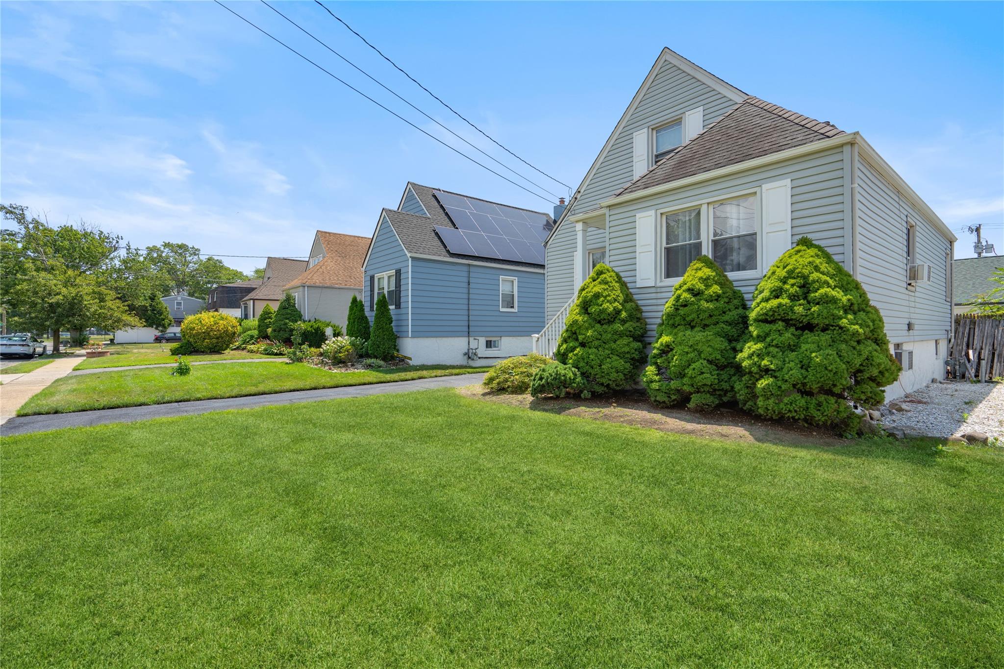 12 Westmoreland Road Merrick, NY 11566 - Photo 10 of 42 front view of a house with a yard