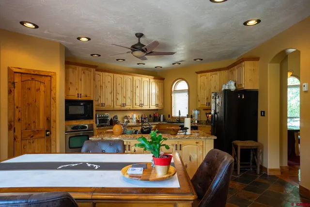 a kitchen with a stove a sink and cabinets