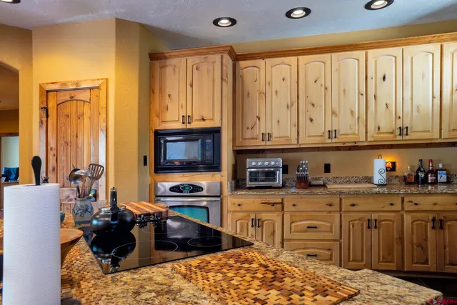 a living room with furniture large window and a fireplace