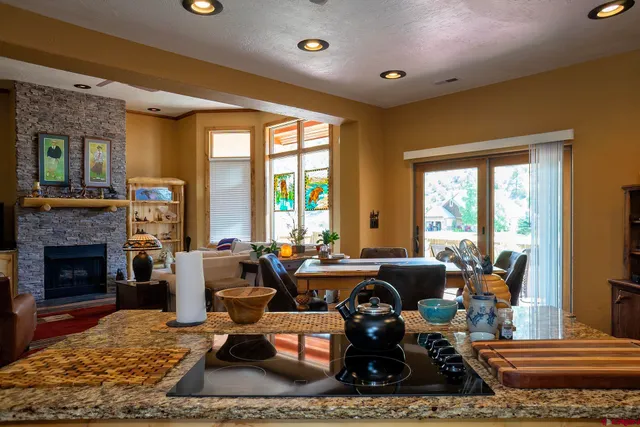 a livingroom with furniture fire place and wooden floor