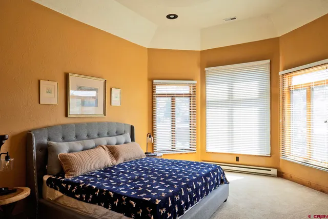 a spacious bathroom with a granite countertop sink and a mirror