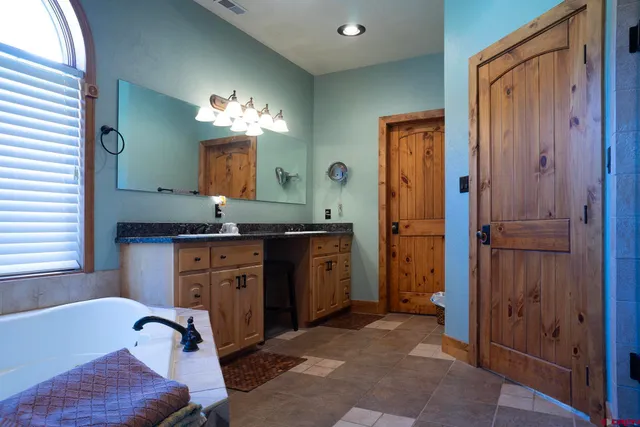 a bathroom with a glass shower door