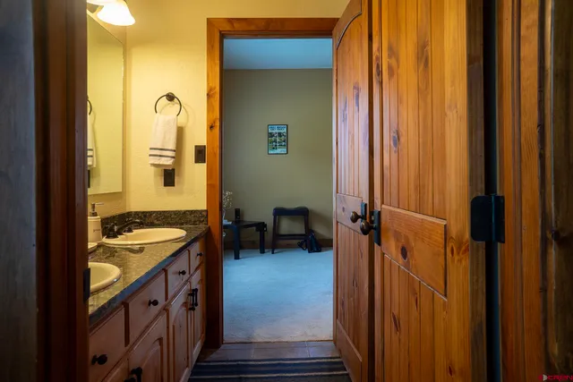 a bathroom with a granite countertop sink and a mirror