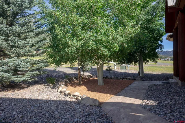 a view of a chairs and table on the wooden roof deck