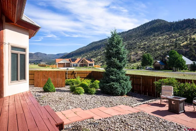 a view of a backyard with sitting area