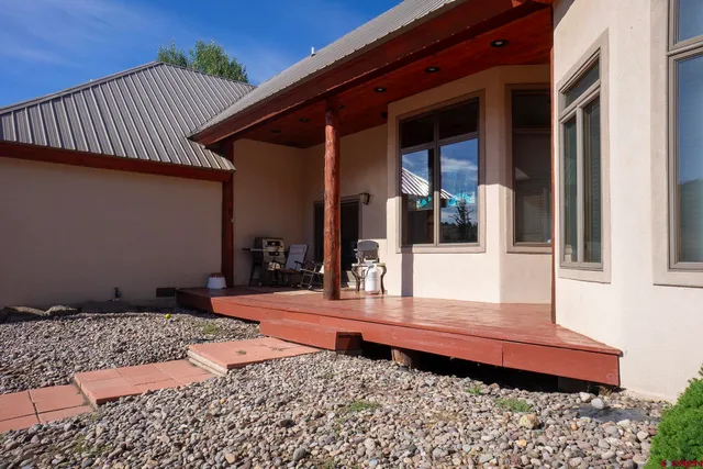 a front view of house with yard and trees in the background