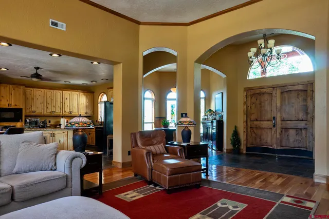 a view of a a dining room with furniture window and wooden floor