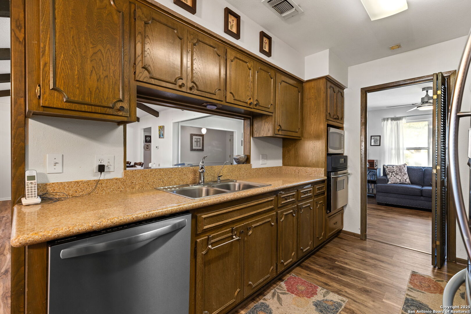 713 Fawndale Lane Windcrest, TX 78239 - Photo 12 of 31 a kitchen with stainless steel appliances granite countertop a sink a stove and cabinets