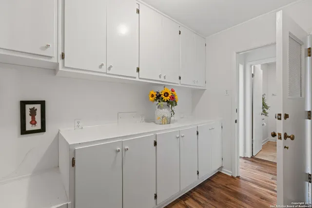 a view of cabinets with wooden floor
