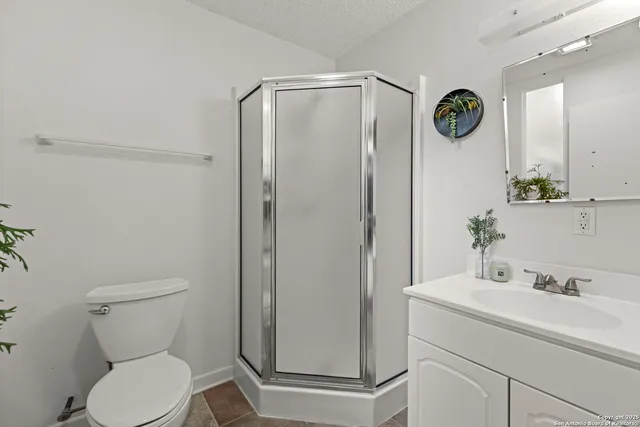 a bathroom with a toilet a sink and a mirror