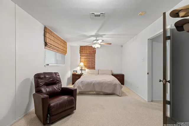 a bedroom with bed and window