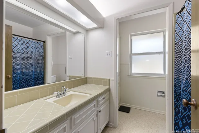 a bathroom with a granite countertop sink mirror and double